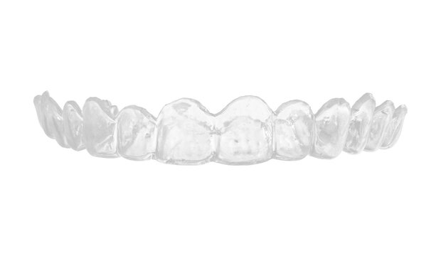 High resolution transparent dental mouth guard with smooth glossy surface and detailed tooth impressions, photographed from the front against white background with minimal shadows, studio lighting