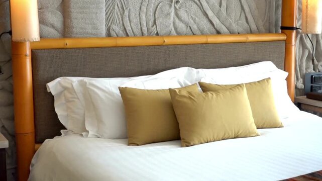 Close up of a bed with white sheets and decorative runner in a hotel room