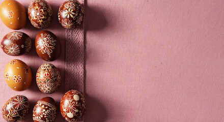painted easter eggs on pink background with copy space