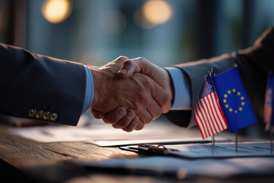 Handshake with Flags: Two figures clasp hands in a gesture of unity and partnership, symbolizing collaboration with the flags of USA and EU in the frame. - Powered by Adobe