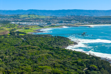 Obraz premium Drone aerial photograph of an old and weathered industrial loading jetty in the South Pacific Ocean near Shellharbour in the Illawarra region on the south coast of New South Wales, Australia. 