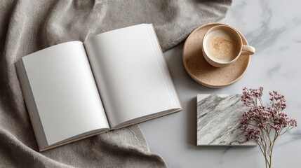 Cozy workspace with blank notebook, cup of coffee, and decorative elements on marble surface