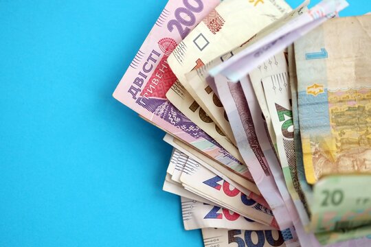 Ukrainian money bills on light blue paper background