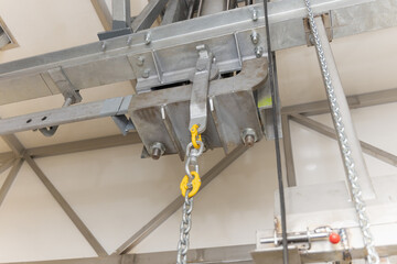 industrial crane hook indoors cold storage room freezers, lifting weights meat in an abattoir, industrial systems