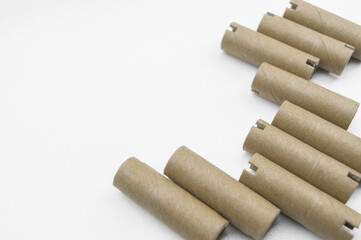 Special cardboard cores for winding paper and film tapes. Paper tubes for winding the products of printing houses. Cardboard tubes on white background. Selective focus
