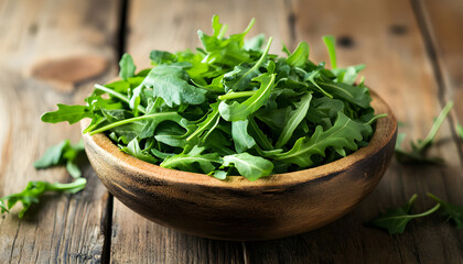 Fresh ripe green arugula leaves on wooden table, closeup. Space for text