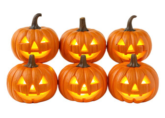 Fototapeta premium A group of six jack o lanterns with glowing faces arranged in two rows on a black background
