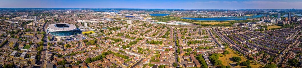Aerial view of Tottenham Hotspur Stadium in London, showcasing its modern architecture and football pitch