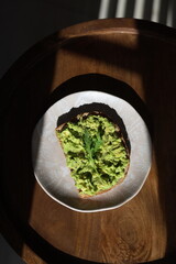 Avocado toast on a table with garnish
