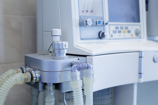 Anesthesia machine with ventilator tubing and controls in modern hospital unit