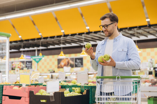Customer Choosing Green Apples in Supermarket