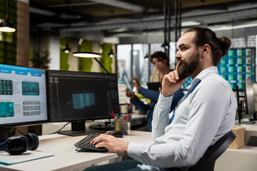 IT engineer reviewing data analysis results with artificial intelligence, integrating machine...