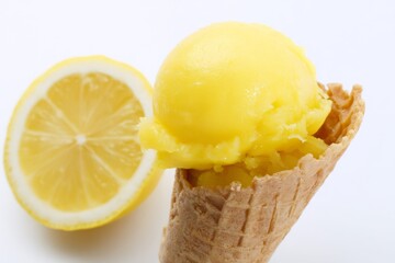A vibrant photo of lemon ice cream served in a crispy waffle cone.
