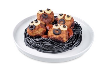 Meatballs with black pasta in the plate for Halloween on a white isolated background