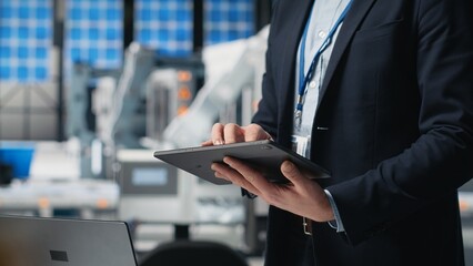 General director doing an inspection in a solar panels manufacturing plant, symbolizing modern production line with equipment for clean energy industry. Sustainable solutions. Camera B.