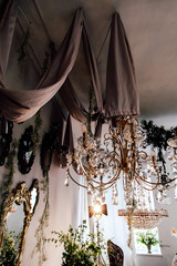 Elegant interior design with chandeliers and draped fabric in a stylish room