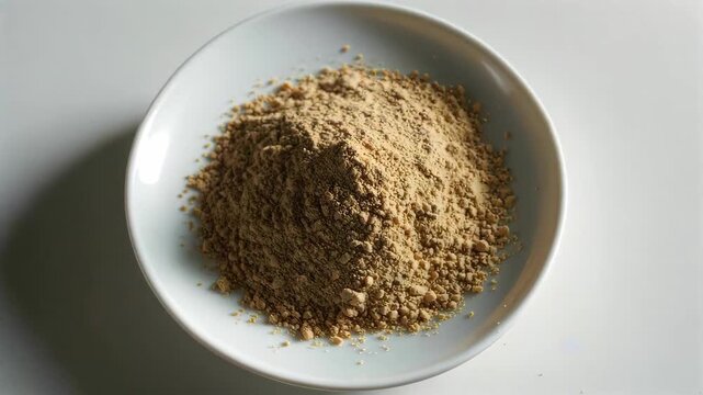 Powdered food in a white bowl Close-up of turmeric powder on a plate