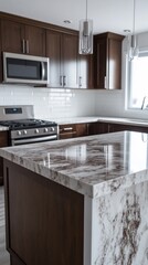 Fototapeta premium Modern kitchen island with polished granite countertop. Dark cabinets and stainless steel appliances. Natural light