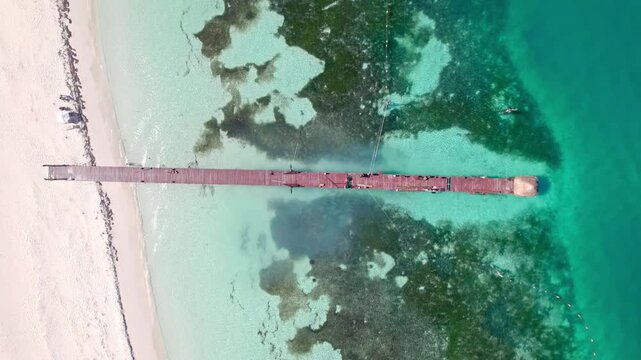 Pier in turqouise water top down view 4K
