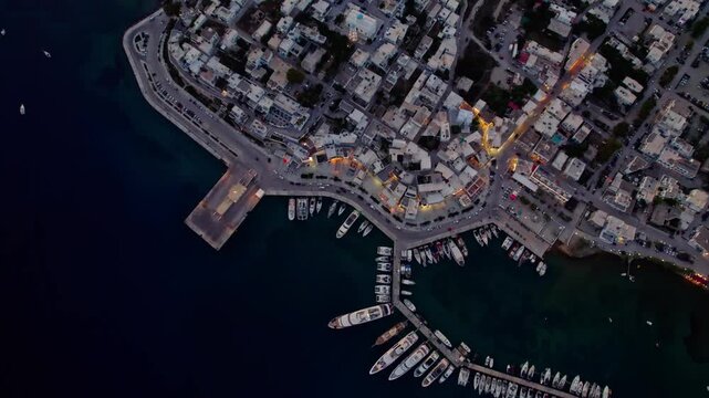 Top down over harbor at nighttime with lights 4K