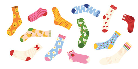 Colorful socks collection with cute patterns. Funny designs with smile faces, bananas, hearts, flowers, animals, dots, stripes, fruits. Cozy warm winter and autumn accessory. Flat vector illustration.