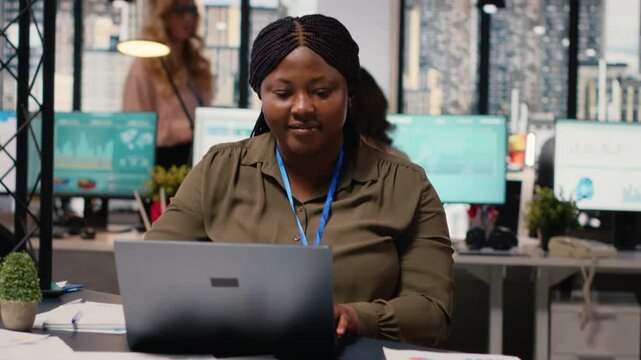 Business consultant analyzing financial data and writes reports in a sleek office, developing the company activity by evaluating the financial situation with graphs and insights on laptop. Camera B.