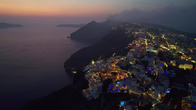 Sunset over cliffside ocean buildings 4K