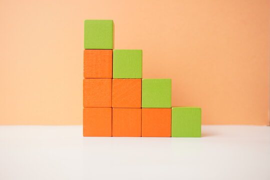 Colorful stack of wooden cubes arranged in ascending order, depicting growth and progress, versatile wooden cubes on clean background for business, health and education concepts.