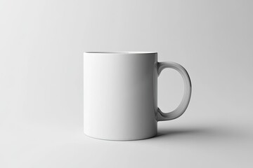 A white ceramic coffee mug featuring a handle is placed on a white surface