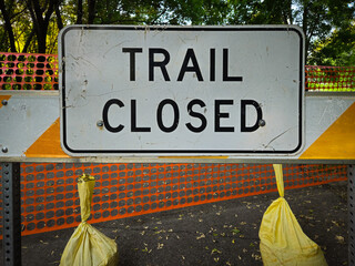 A "TRAIL CLOSED" sign, indicating that the path or trail ahead is inaccessible. Construction and infrastructure design element © mailcaroline