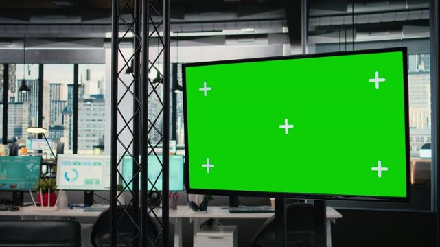 Empty boardroom with green screen and advanced digital tools hinting at business development, forecasting through strategic planning and data analysis in an empty office. Project agenda.