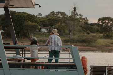 Mother and Daughter Fishing off Jetty at Sunset