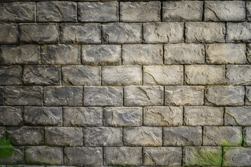 Realistic textured stone brick wall background with natural cracks and weathered surface, high-resolution pattern for architecture, construction, design, and urban industrial backdrop projects