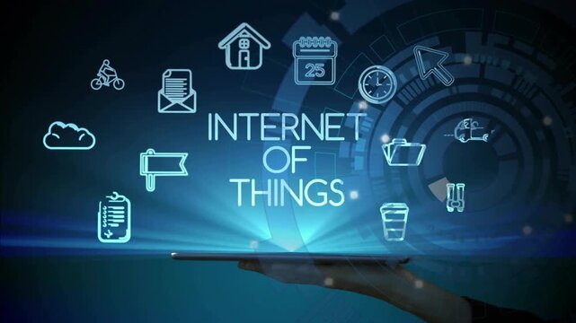 Hand holding tablet hovering sparking Internet of Things text and summoning icons in flat design