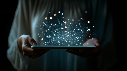 Woman is holding a tablet with a glowing blue screen. Concept of wonder and excitement, as if the woman is holding a magical device that can transport her to another world