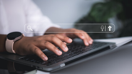 Internet search, AI integration, and the role of digital technology in modern business and daily life. User typing on laptop with virtual search bar overlay.