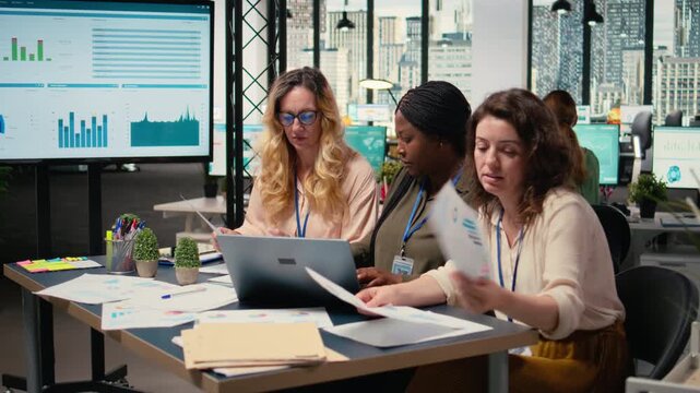 Businesswomen harness the power of analytics and teamwork, advancing the company development through effective planning and collaborative leadership. Review results and progress. Camera A.