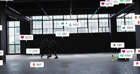 Training partners dribbling and defending in loft causing notifications flooding basketball court - Powered by Adobe