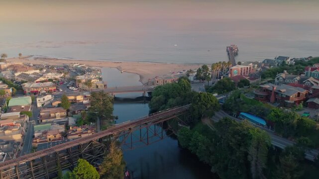Aerial view of Capitola, California, USA, showcasing the beach, pier, and the Soquel Creek flowing into the Monterey Bay. Captures the town's coastal charm.