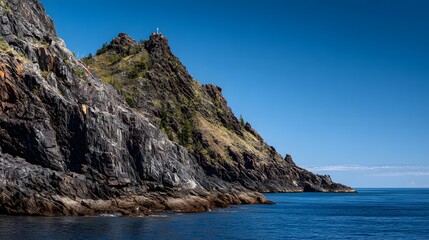 Rugged coastal cliffs meet a calm ocean.