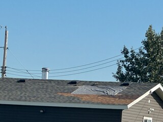 Roof repair. Broken shingles on a rooftop
