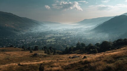 Breathtaking panoramic view of lush green valley surrounded by misty mountains du daytime with cloudy sky and serene natural landscape scene