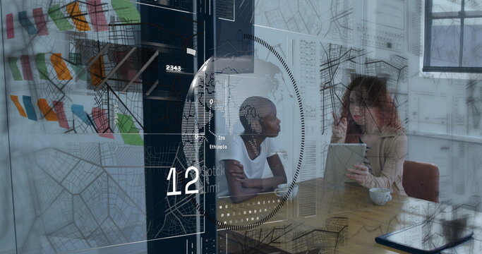 Discussing data on tablet two coworkers seated at wooden table in modern office, with sticky notes - Powered by Adobe