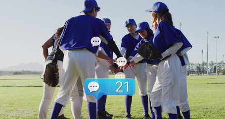 Forming circle of seven women athletes joining hands on grass field, with baseball gloves and caps