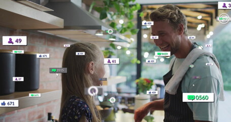 Cooking father and daughter mixing ingredients in home kitchen, showing floating social media icons