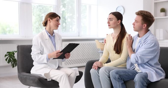 In vitro fertilization (IVF). Doctor encouraging couple during visit in reproductive clinic