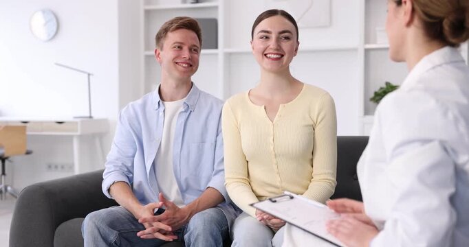 In vitro fertilization (IVF). Doctor shaking hands with couple during visit in reproductive clinic