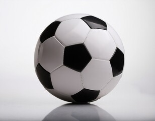 Fototapeta premium stock photo of a classic black and white soccer ball on a clean surface for sports marketing use