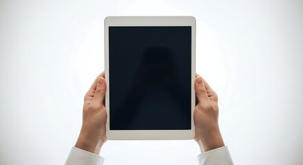 Hands holding a blank tablet computer with a dark screen on a white background image photo