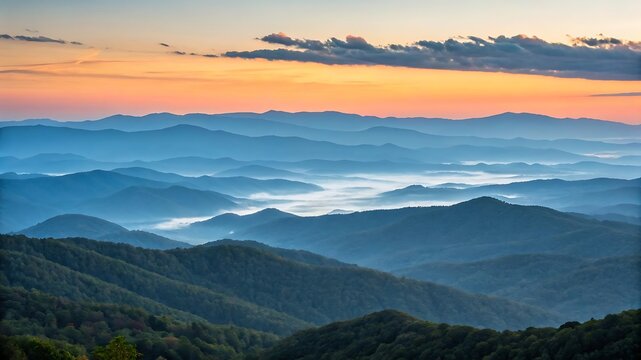 Layered blue mountains misty sunrise landscape